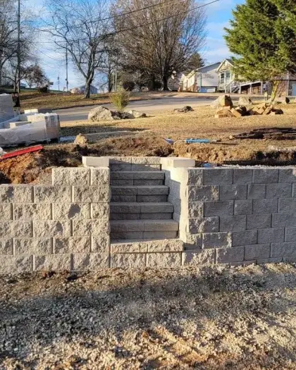 Block retaining wall with an inset stairway on a Titan job site